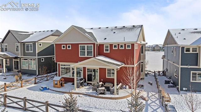 snow covered back of property featuring central air condition unit