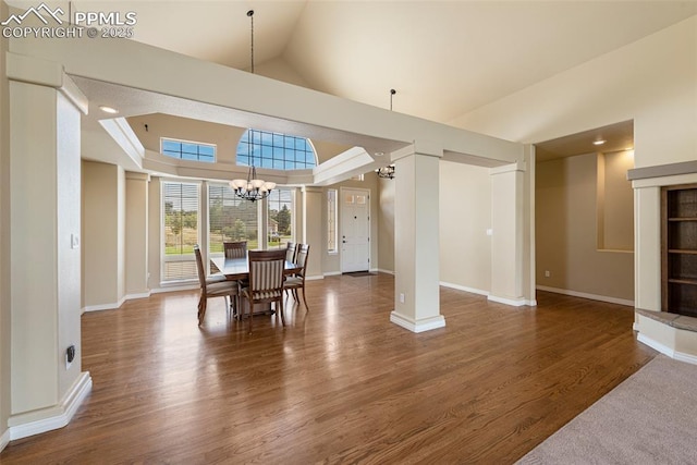 dining room featuring vaulted ceiling, a chandelier, and dark hardwood / wood-style floors