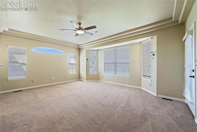 empty room featuring ceiling fan and light carpet