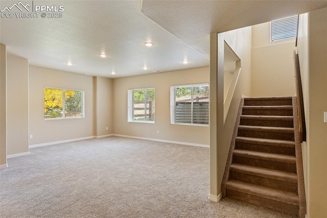 stairs with carpet and a textured ceiling