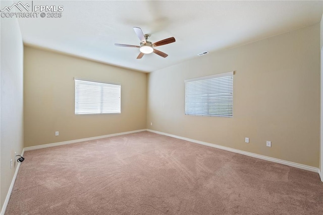 carpeted empty room featuring ceiling fan