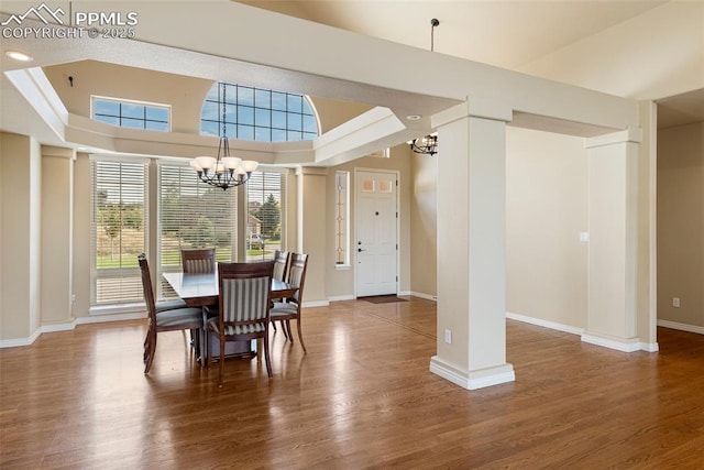 dining area with wood-type flooring and a chandelier