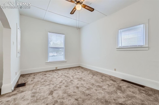 spare room with ceiling fan and carpet