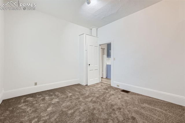 empty room featuring carpet flooring