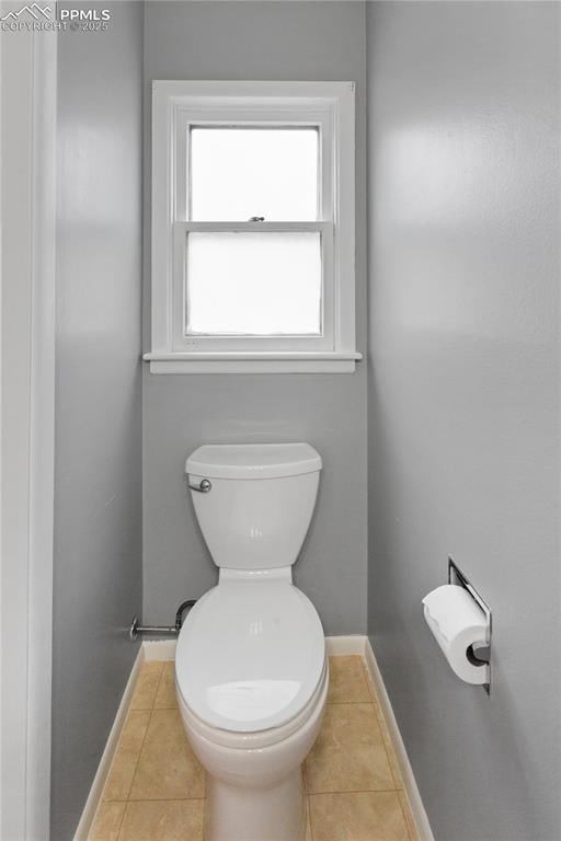 bathroom with tile patterned flooring and toilet