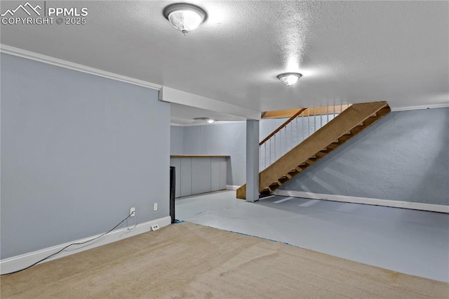 basement with a textured ceiling and ornamental molding