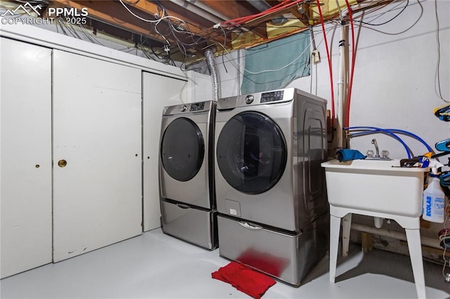 clothes washing area featuring washer and dryer