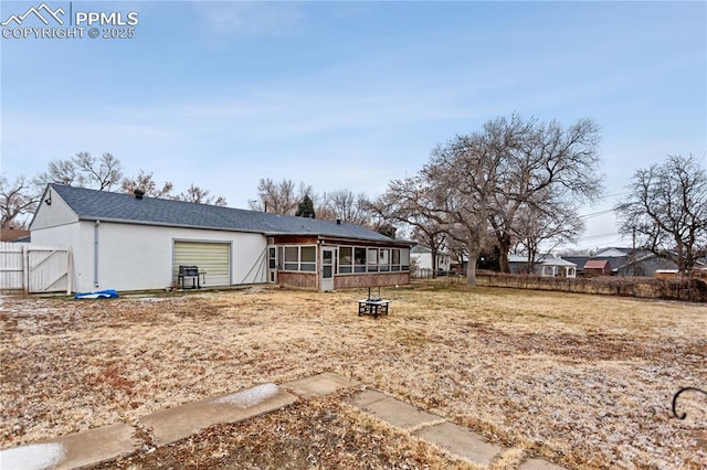 rear view of house featuring a sunroom