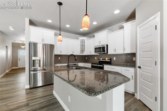 kitchen featuring pendant lighting, sink, an island with sink, and stainless steel appliances