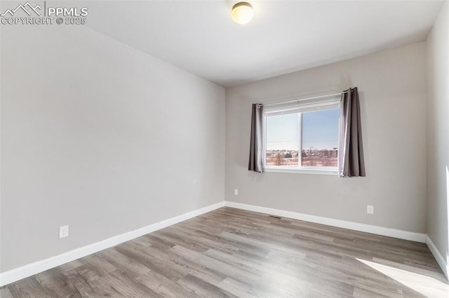 spare room featuring light hardwood / wood-style flooring