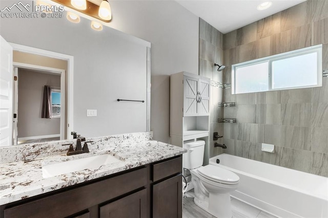 full bathroom with vanity, toilet, and tiled shower / bath