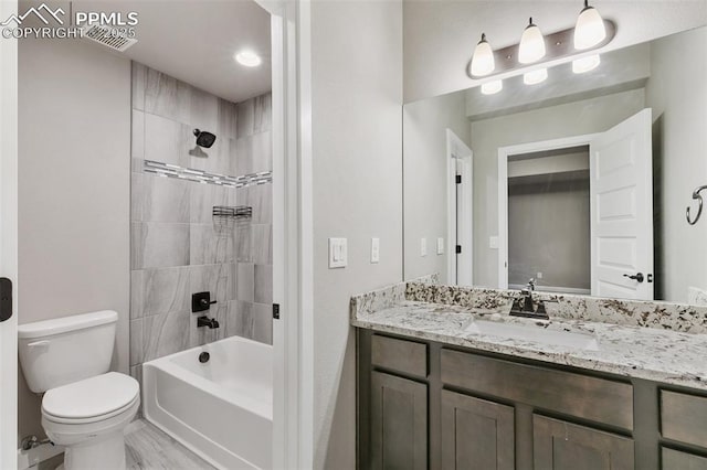 full bathroom with vanity, toilet, and tiled shower / bath