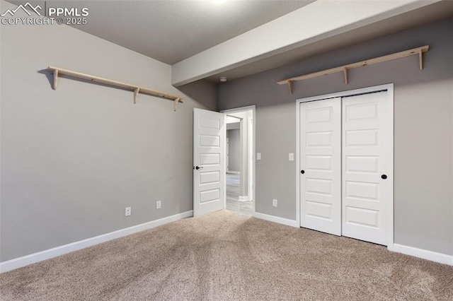 unfurnished bedroom with carpet floors and a closet