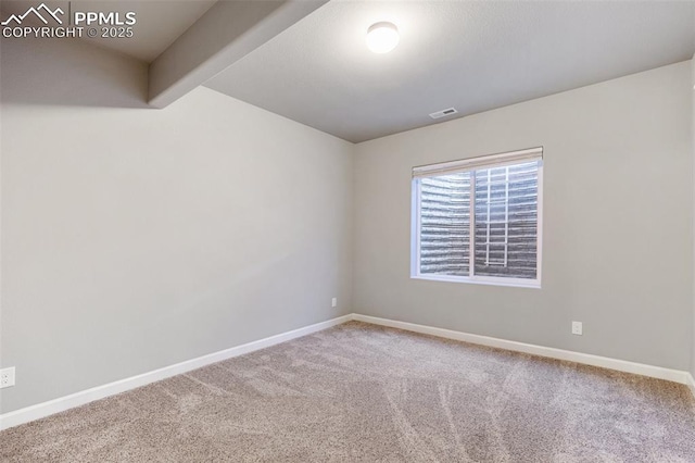 empty room with beamed ceiling and carpet floors