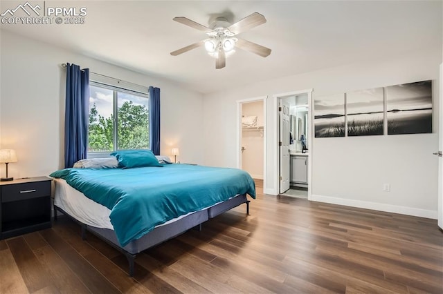 bedroom featuring a closet, a spacious closet, ceiling fan, and dark wood-type flooring