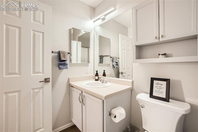 bathroom featuring vanity and toilet