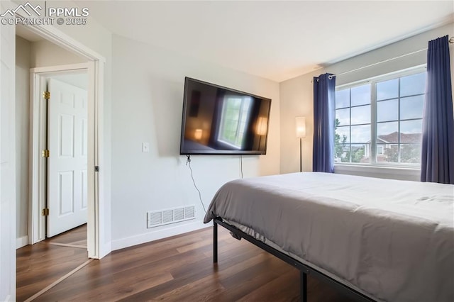 bedroom featuring dark hardwood / wood-style flooring