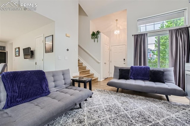 living room with hardwood / wood-style flooring and a notable chandelier