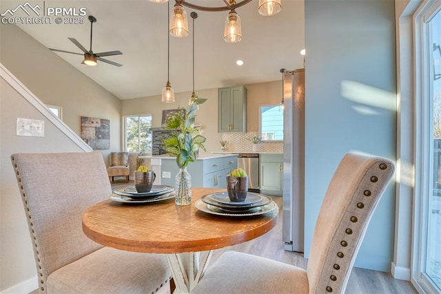 dining area with lofted ceiling, ceiling fan, and light hardwood / wood-style floors