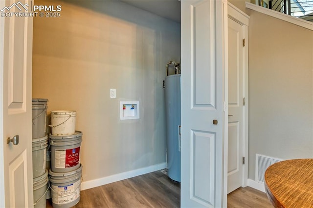 laundry room featuring washer hookup, water heater, and hardwood / wood-style flooring