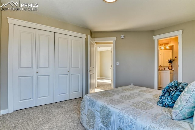 bedroom featuring ensuite bathroom, carpet floors, a closet, and sink