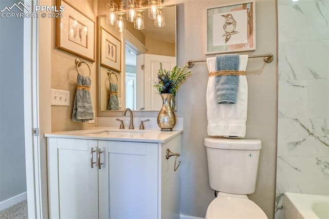 bathroom with toilet, vanity, and a tub