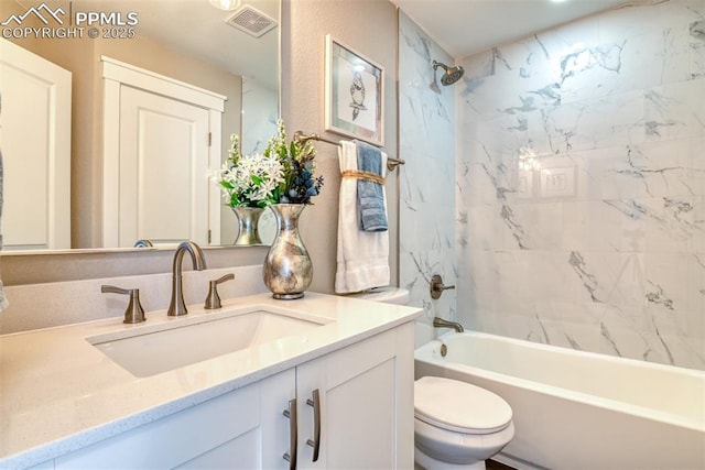 full bathroom with toilet, vanity, and tiled shower / bath