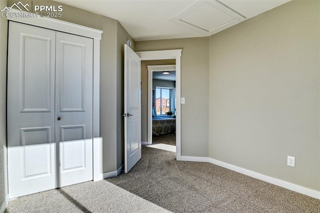 unfurnished bedroom featuring a closet and carpet floors