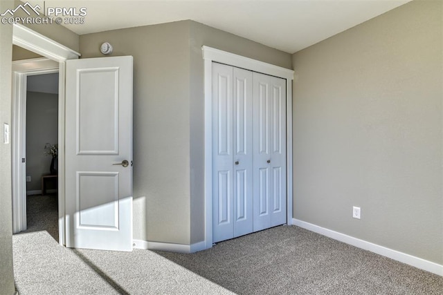 unfurnished bedroom featuring a closet and carpet flooring