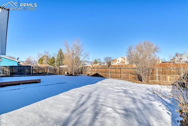 view of yard layered in snow