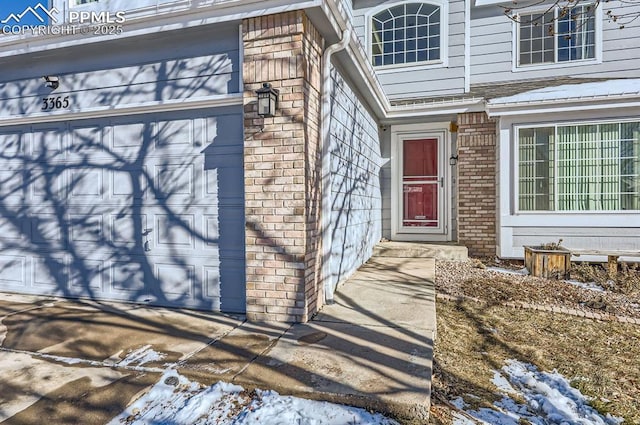 view of snow covered property entrance