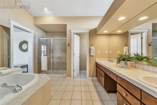 bathroom with tile patterned flooring, vanity, and shower with separate bathtub