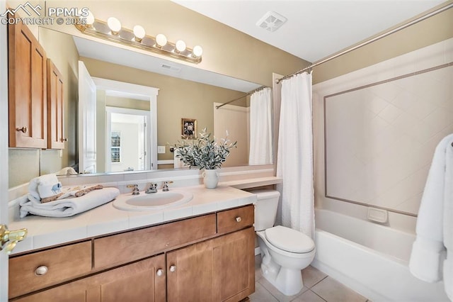 full bathroom featuring toilet, shower / bath combo, vanity, and tile patterned floors