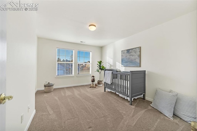 bedroom with light colored carpet and a crib