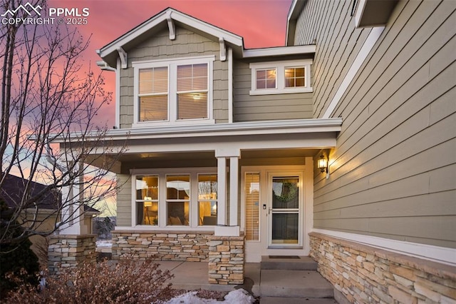 exterior entry at dusk with covered porch