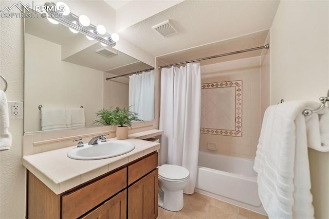 full bathroom with shower / bath combo, vanity, a textured ceiling, tile patterned flooring, and toilet