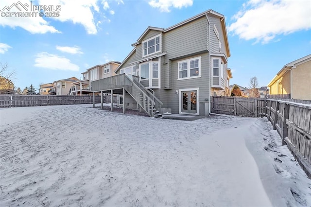 snow covered property featuring a wooden deck