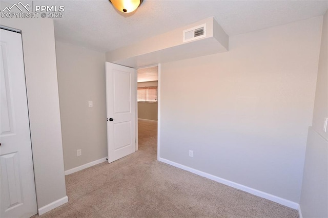 unfurnished room with light colored carpet