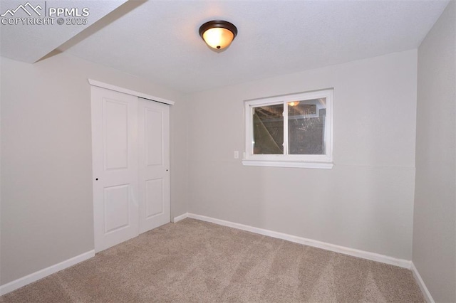 unfurnished bedroom with a closet and carpet floors