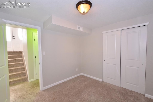 unfurnished bedroom featuring a closet and carpet floors