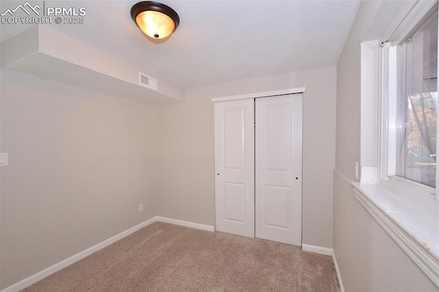 unfurnished bedroom with a closet and carpet