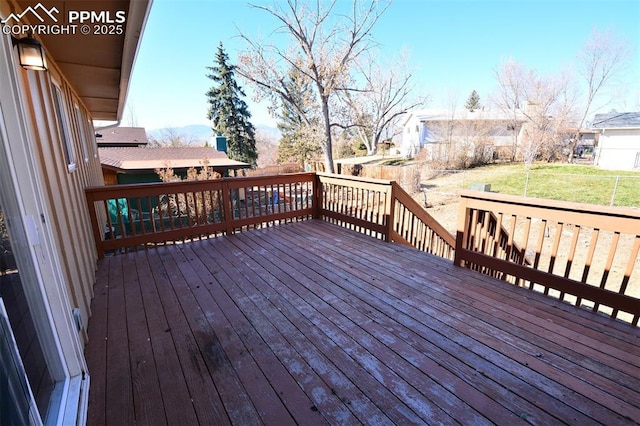 wooden terrace featuring a yard