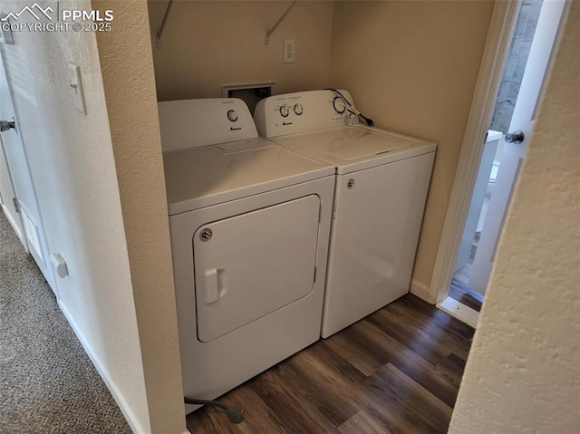 laundry room with laundry area, baseboards, dark wood-style flooring, and washing machine and clothes dryer