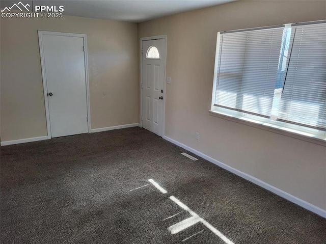 entryway with baseboards, carpet floors, visible vents, and a healthy amount of sunlight