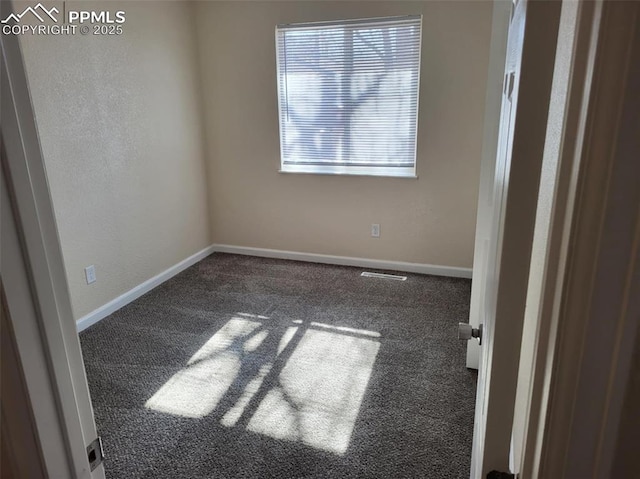 unfurnished room featuring carpet floors, visible vents, and baseboards