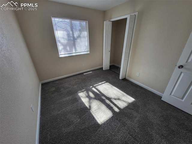 unfurnished bedroom with carpet floors and baseboards