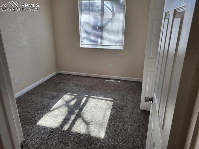 carpeted empty room with visible vents and baseboards