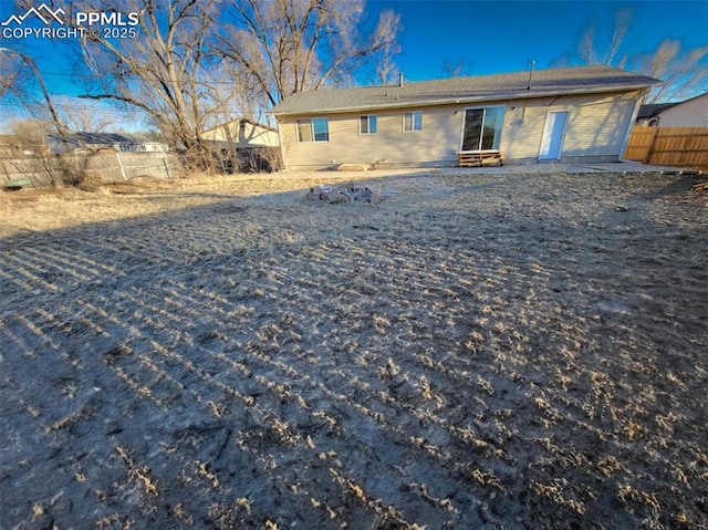 rear view of property with fence and a patio