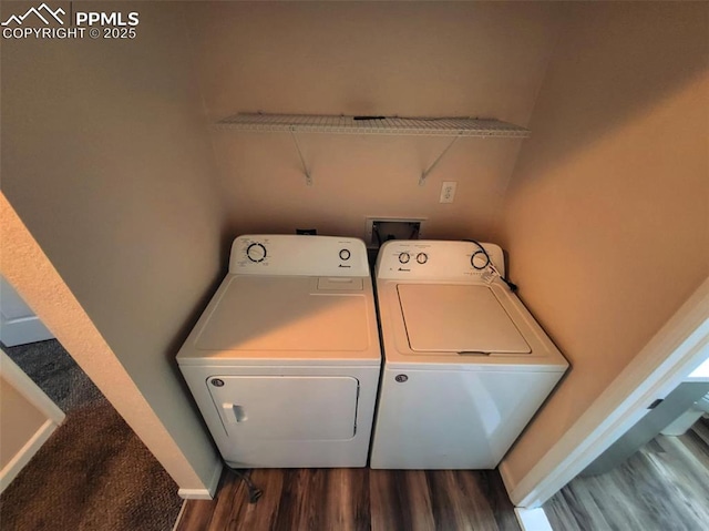 washroom with washer and dryer, laundry area, baseboards, and wood finished floors