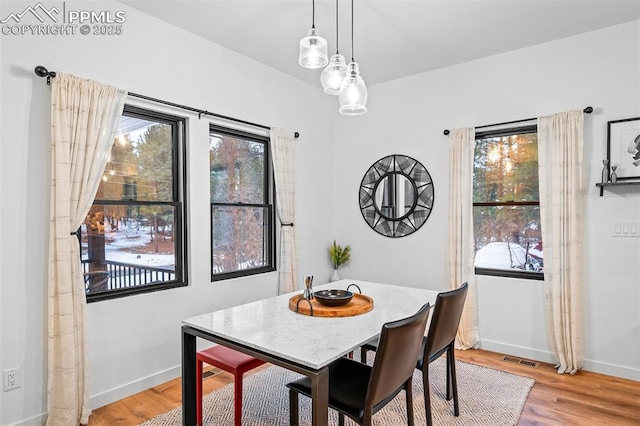 dining area with light wood-type flooring